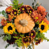 A beautiful assortment of fall tones elegantly arranged in a keepsake ceramic