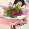 A bouquet of flowers in shades of pink full of love.
Made and