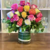 Colorful blend of roses in a clear glass vase. 