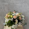 A soft and romantic mix of peach-colored flowers, designed with elegance and