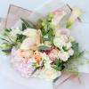 A sumptuous bouquet of delicate calla lilies, elegant pink hydrangea, and graceful