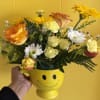 Cute smiley mug with blooms. Mix of yellow flowers.