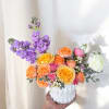 This arrangement features a unique mix of fresh flowers, varying each week