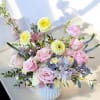 This arrangement features a unique mix of fresh flowers, varying each week