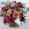 Loads of vibrant autumn blooms packed a 5x5 glass cube. Approximately 16