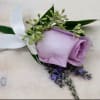 Orchid or rose boutonniere include seasonal greens, and a ribbon in the