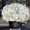 Amazing fresh flowers arrangement of white flowers with a shiny crown on