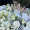 Amazing fresh flowers arrangement of white flowers with a shiny crown on