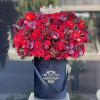 A total red arrangement of fresh flowers in our signature black velvet