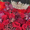 A total red arrangement of fresh flowers in our signature black velvet