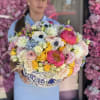 Arranged in a beautiful withe and blue vase with anemones, coral peonies