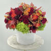 White ceramic vase with fresh bright autumn inspired arrangement 