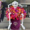 Pink and orange arrangement of fresh flowers in our signature burgundy velvet