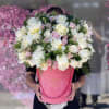 Coral velvet box with peonies, roses and decorative greenery. 