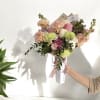 A thoughtfully designed bouquet, artfully arranged in a stylish cone wrap. Colors