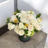 A timeless blend of elegance and natural charm, this arrangement features soft