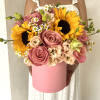 Contains golden sunflowers surrounded by an array of complementary blooms in warm