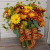 Fall daisies mixed in a clear vase with fall fillers.  