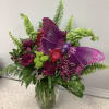 Large butterfly in a vase of seasonal flowers 