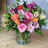 The Simply You is a fun vase arrangement with lilies, roses, spray