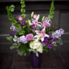 Delivered in a large glass vase, is a grouping of beautiful flowers