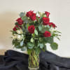 12 beautiful long stem red roses arranged with greenery and filler flower.