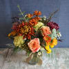Fresh fall flowers in a cylinder vase. Approximatley 15&quot; tall x 10&quot;