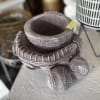 A baseball mitt with baseballs, stone planter. The price listed includes the
