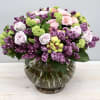Standard size of this arrangement has roses lilacs and viburnum. Premium will