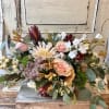 A subtle color scheme with seasonal fresh flowers, foliage and dried elements