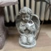 A praying angel who is kneeling. 
