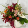 Fun and festive, this Fall flower arrangement features Autumn hues of stock