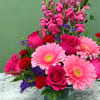 A charming mixed arrangement that showcases a romantic red and pink palette.