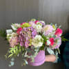 This design includes dahlias, roses, and hydrangeas arranged with eucalyptus and stock