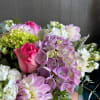 This design includes dahlias, roses, and hydrangeas arranged with eucalyptus and stock