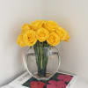 A radiant display of premium yellow roses, meticulously arranged in a modern
