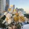 Creamy white roses and golden accents intertwine with natural wheat in a