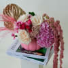 Delicate white roses and playful pink blooms combine with pink hydrangea in