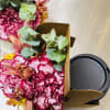 Cup of pumpkinspice coffee and a floral arrangement to brigten someones fall