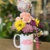 Fresh flowers in coffee mug 