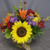 Colorful fall flowers fill this cylinder vase and are accented with faux