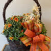This rustic basket is filled with a bright and festive hardy mum