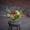Wonderful bleached wheat whisps from pretty vintage-toned fall blooms in a shallow