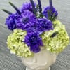 This fun and eye-catching arrangement is designed in a glossy white ceramic