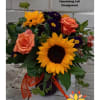 Sunflowers, roses, alstromeria and other seasonal goodies arranged in bright yellow, orange