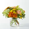 Peach roses and bronze cushion chrysanthemums set against green mini hydrangea welcome