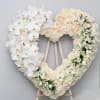 This elegant sympathy heart wreath is made with white roses and a