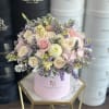 A delicate signature flower box featuring a soft assortment of pink, white