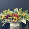 This floral arrangement comes in a beautiful ceramic bowl with leaves and