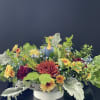 This floral arrangement comes in a beautiful ceramic bowl with leaves and